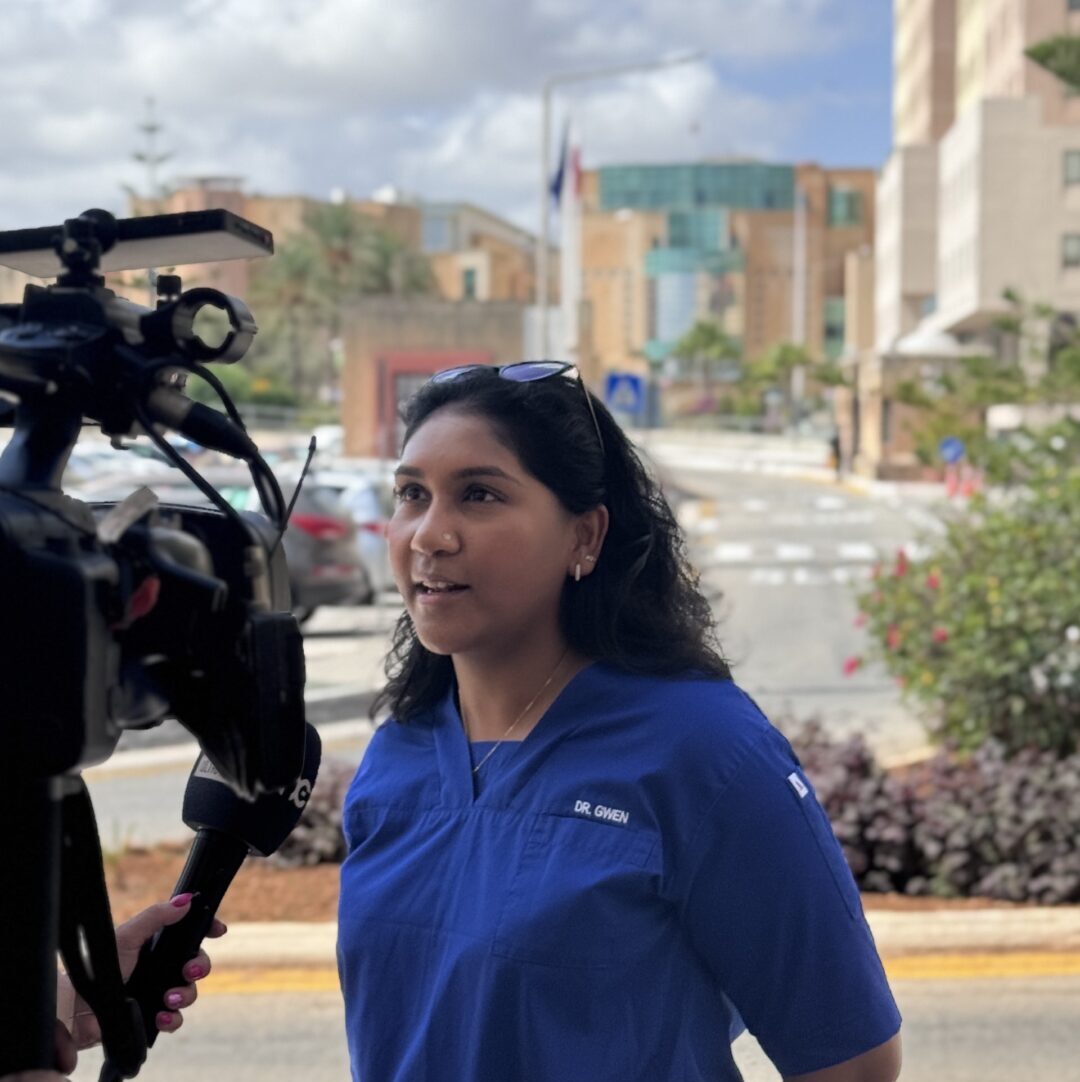 Gwen being interviewed by a news outlet on site